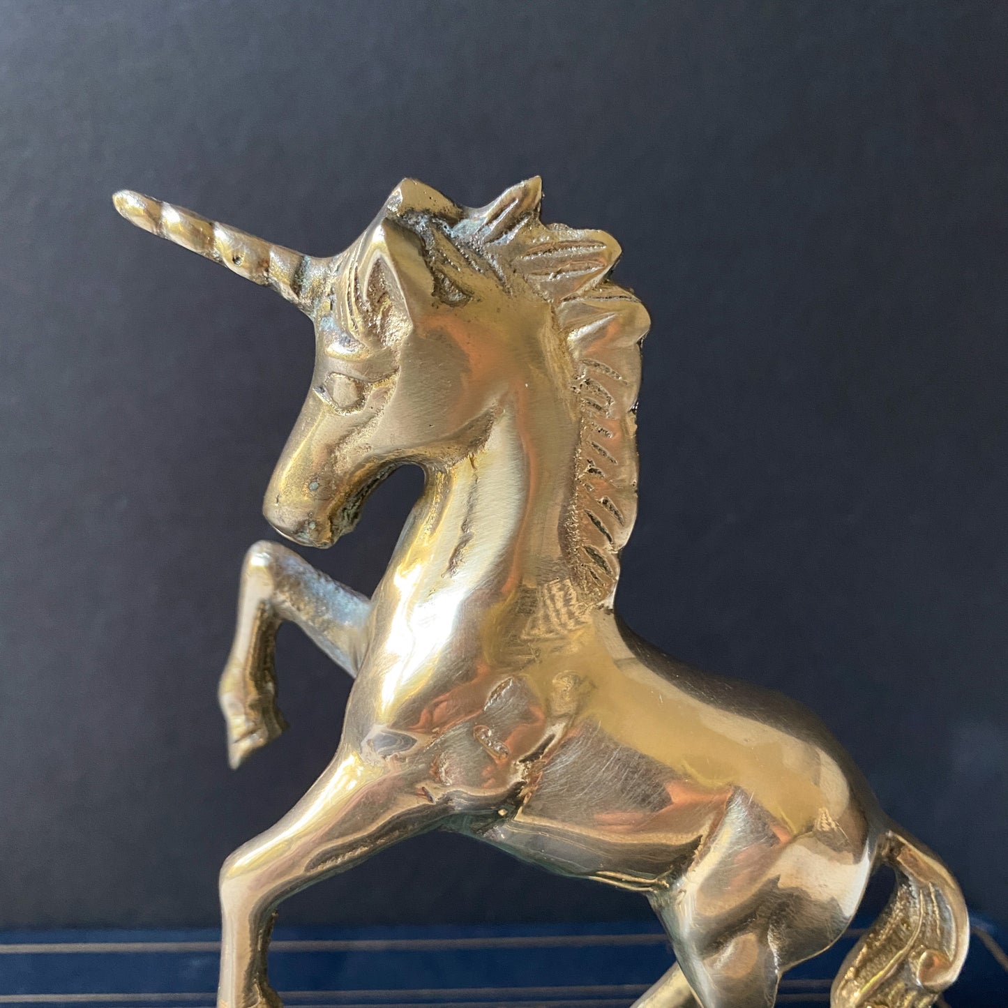 Vintage brass unicorn sculpture on marble