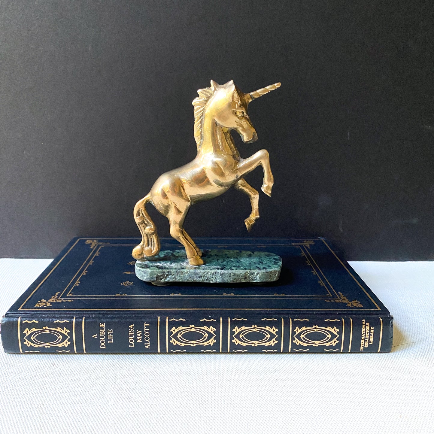 Vintage brass unicorn sculpture on marble