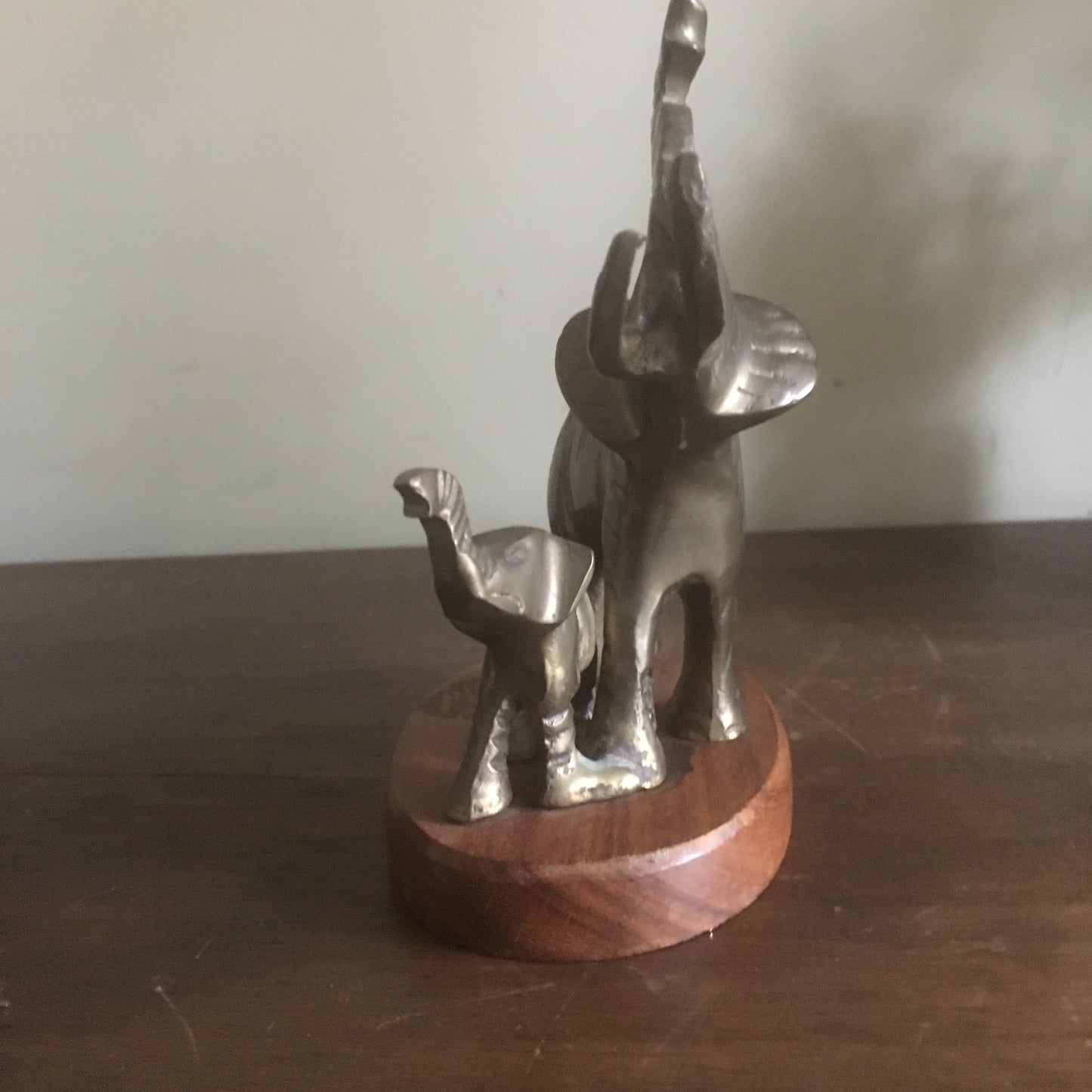 Brass mom and baby elephant sculpture on wood