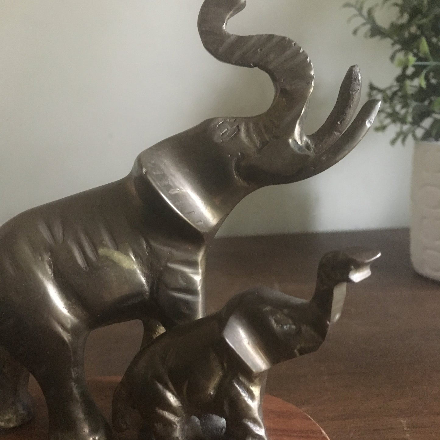 Brass mom and baby elephant sculpture on wood